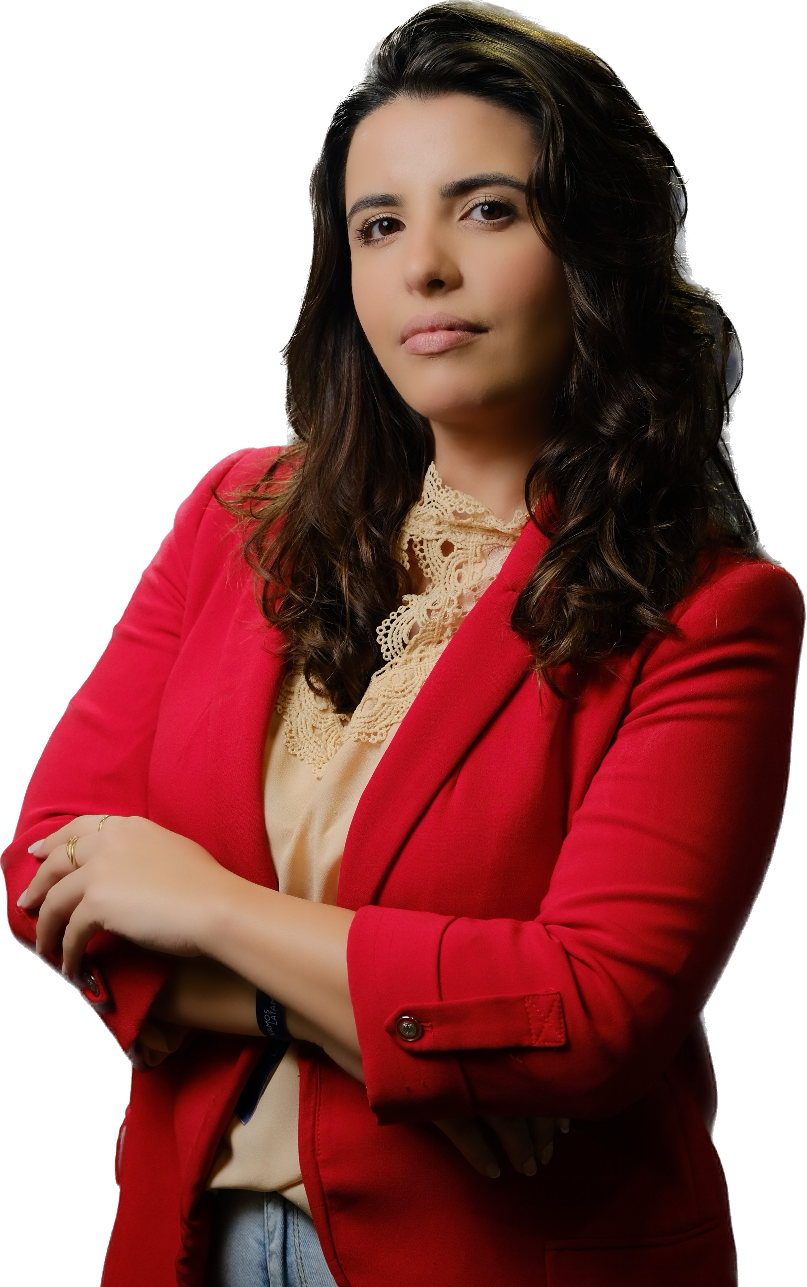White Mediterranean-style house with a terracotta roof, surrounded by lush greenery and partially obscured by vibrant red-orange flowers in the foreground
